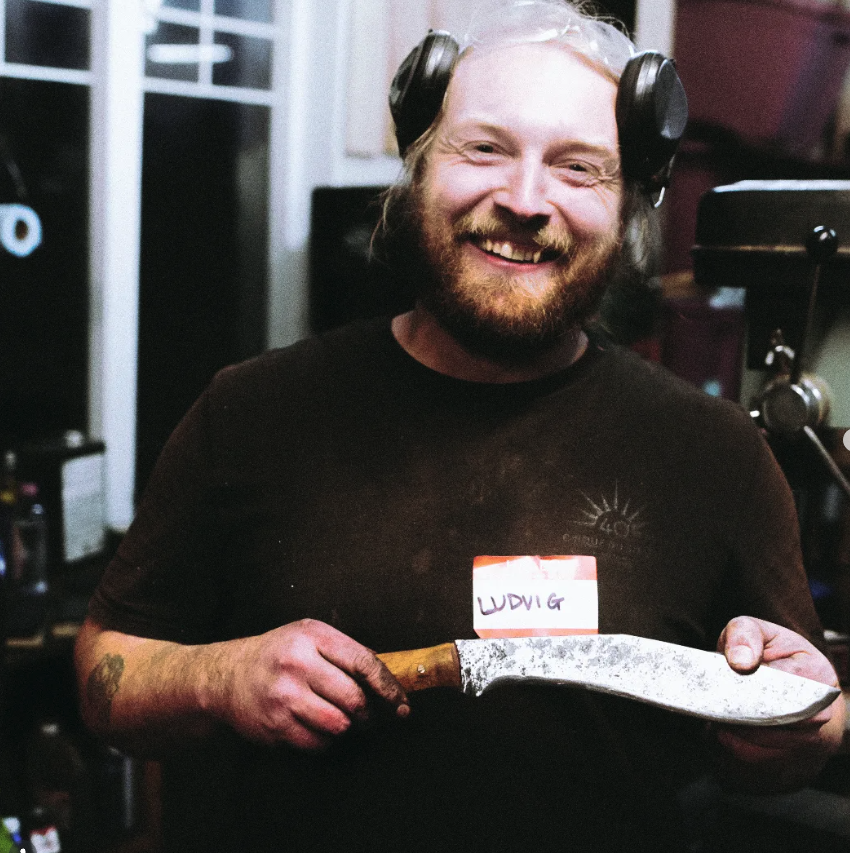 Ludvig Germain Auclair holding a knife in his workshop